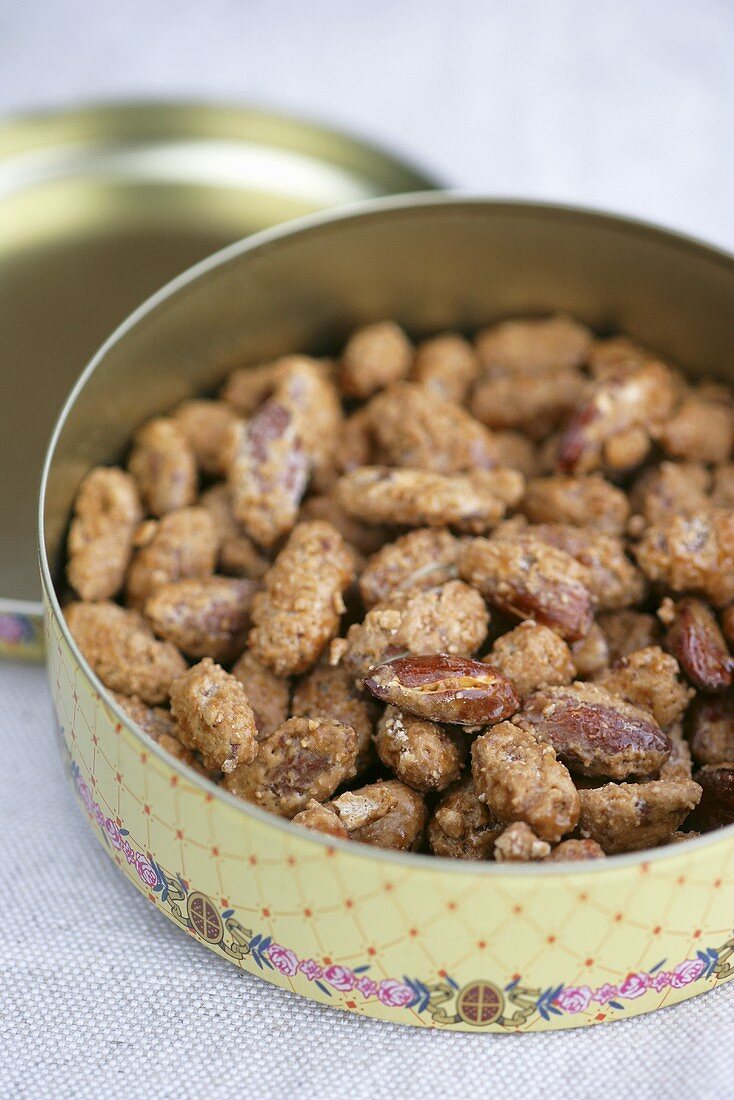Roasted almonds in a round metal tin