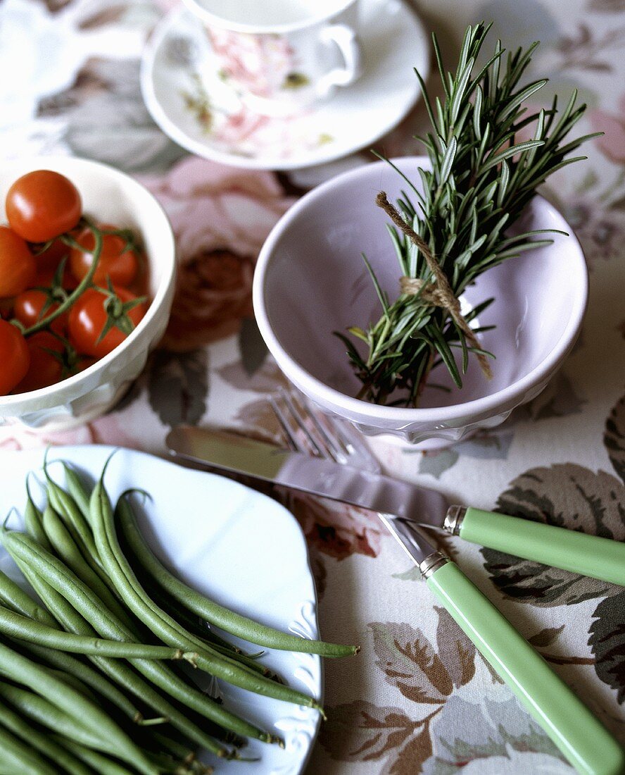 An arrangement of green beans and rosemary