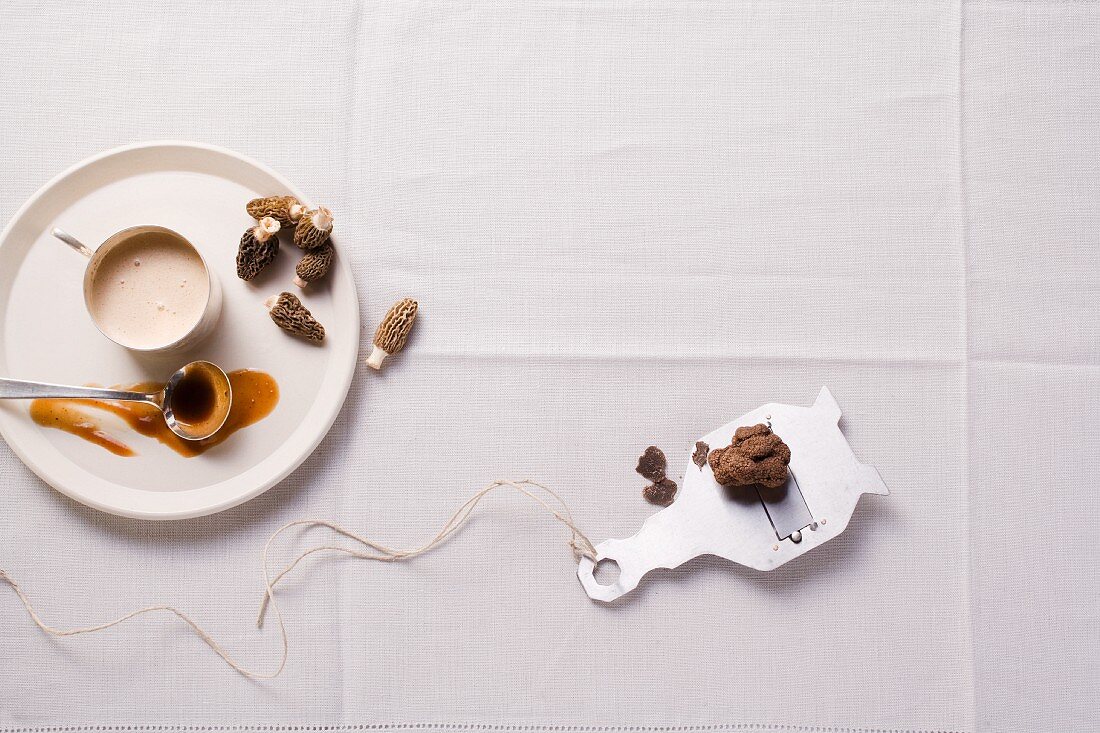 Morel sauce and black truffles on a truffle grater