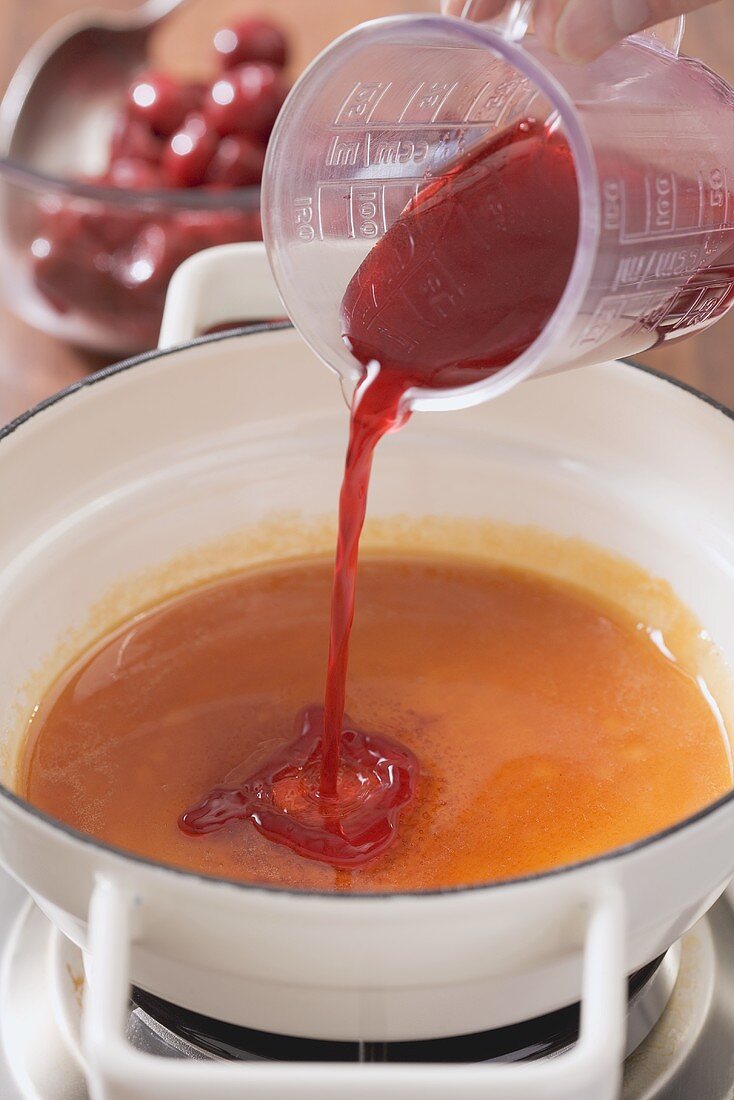 Cherry juice being added to game sauce