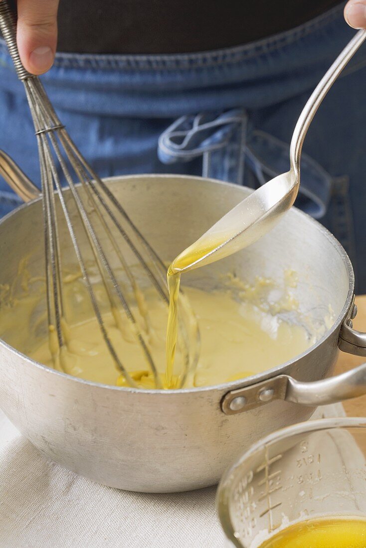 Clarified butter being folded into egg cream