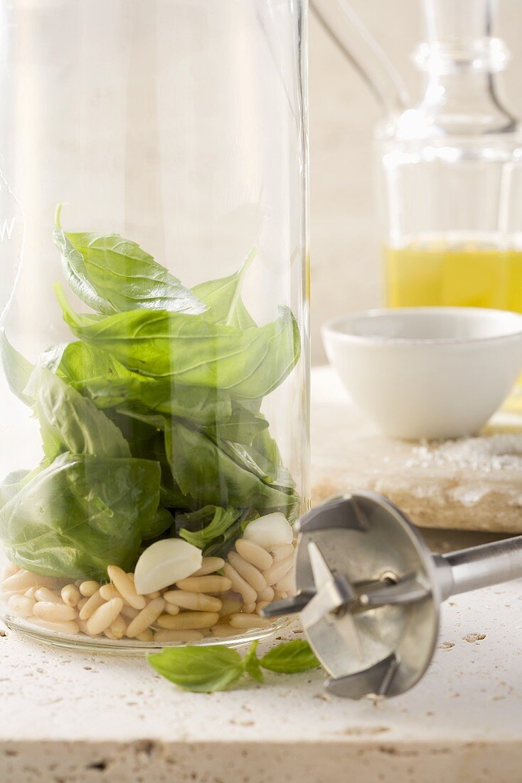 Basil leaves, pine nuts and garlic in a measuring jug