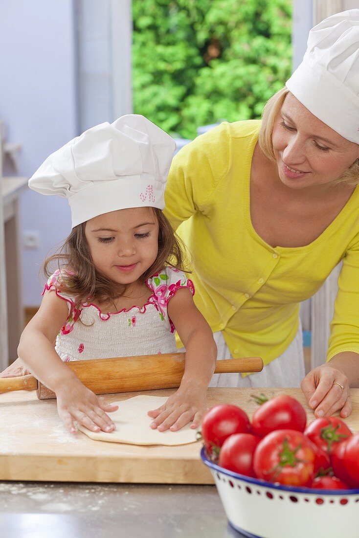 A mother and daughter making a pizza