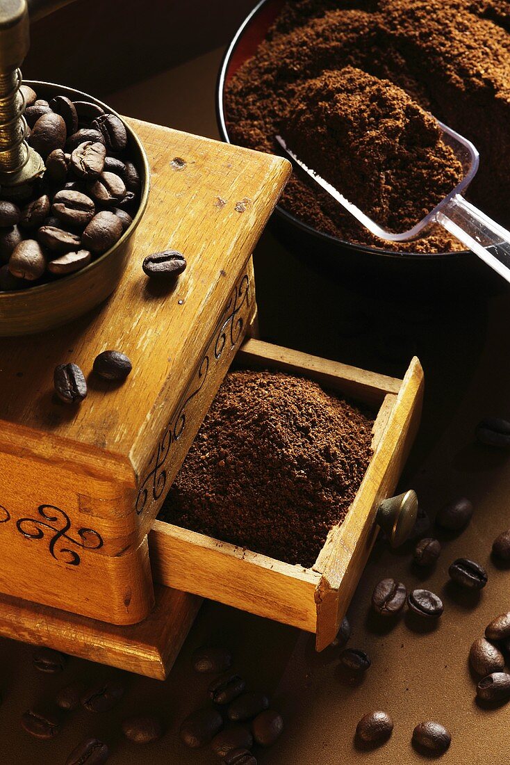 Whole and ground coffee beans from a hand coffee grinder
