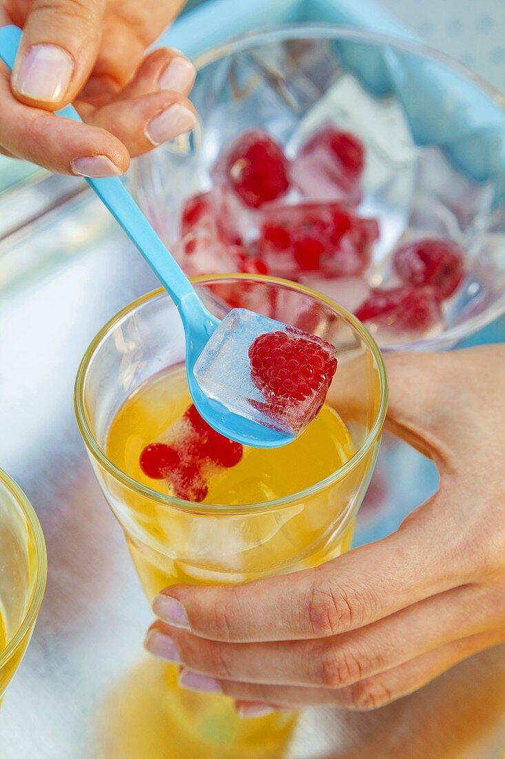 Orangeade with berry ice cubes