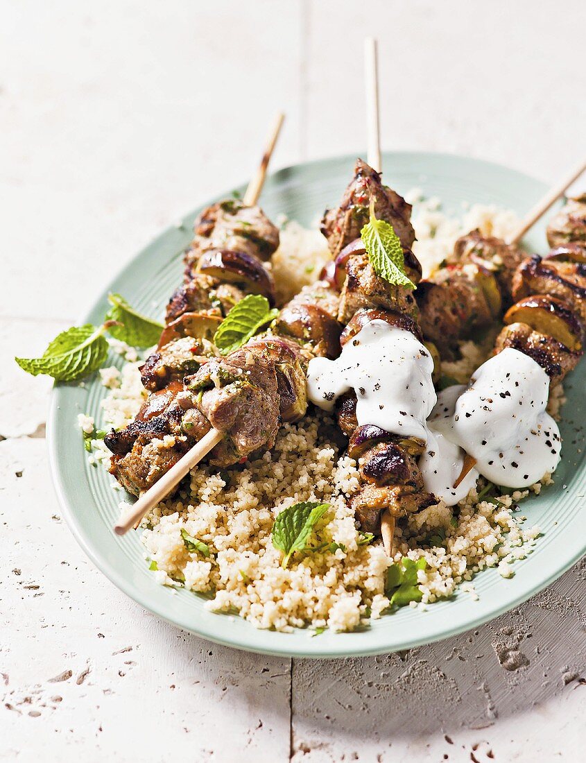 Eggplant-lamb skewers with yogurt on couscous