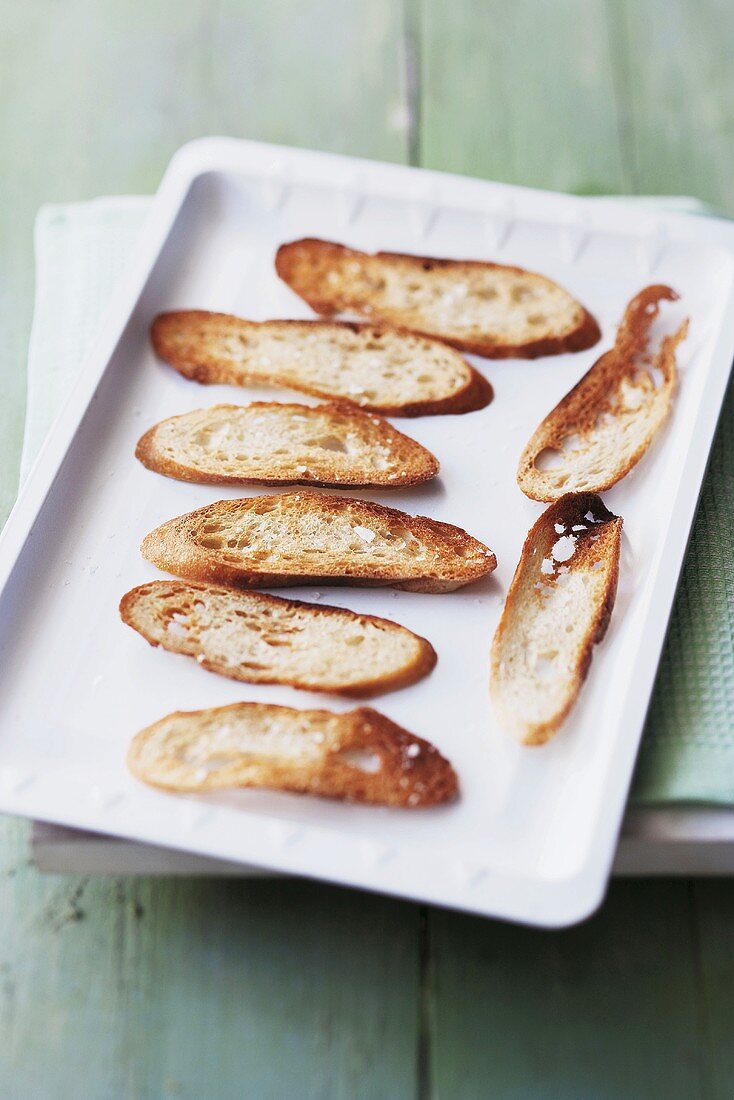 Geröstete Baguettescheiben auf einem Backblech