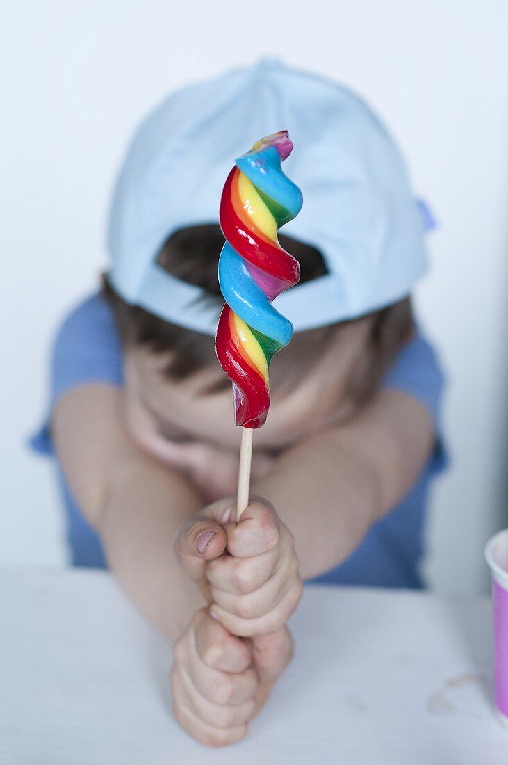 Young boy with a spiral shaped lollipop