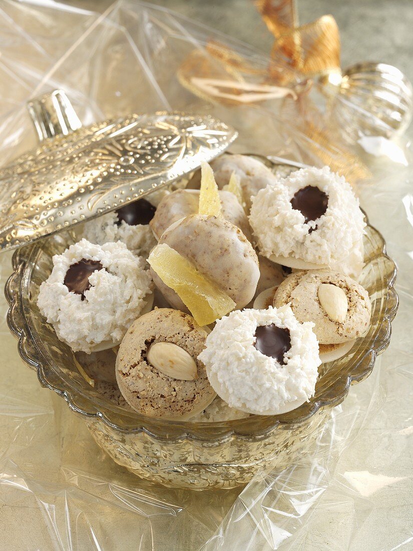 Assorted macaroons (almond, pineapple, coconut) in a crystal bowl