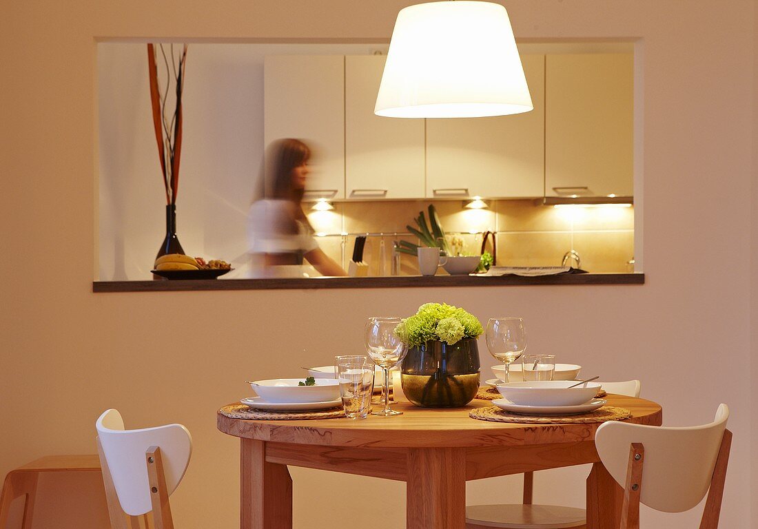 A dining area with a serving hatch into the kitchen