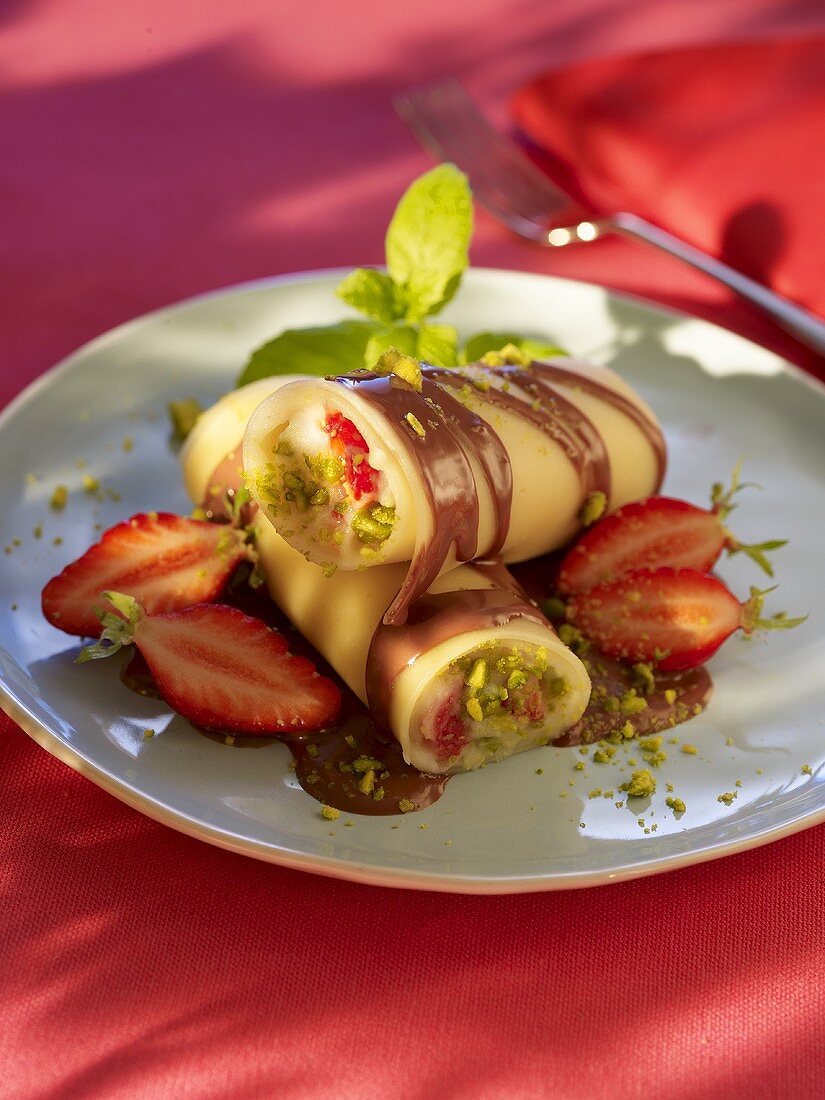 Sweet Cannelloni with strawberries, pistachios and chocolate sauce
