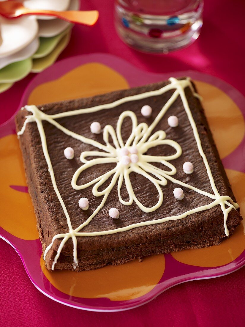 Chocolate cake decorated with a flower made with icing