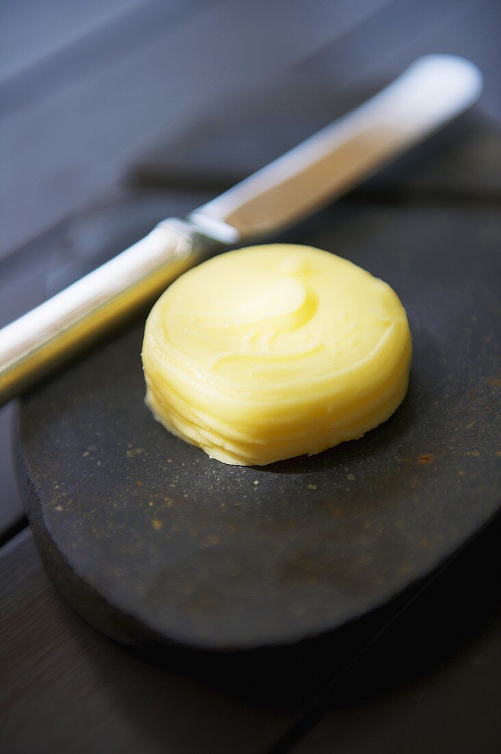 A pat of butter with a knife