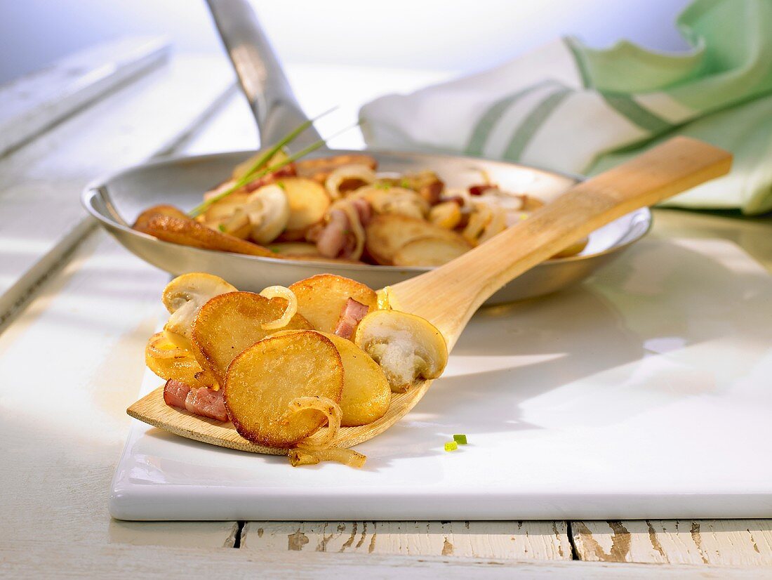 Roast potatoes with onions, bacon and mushrooms