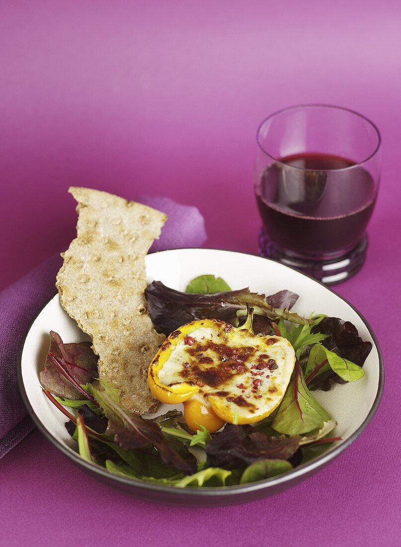 Yellow peppers with cheese filling on salad with crispbread