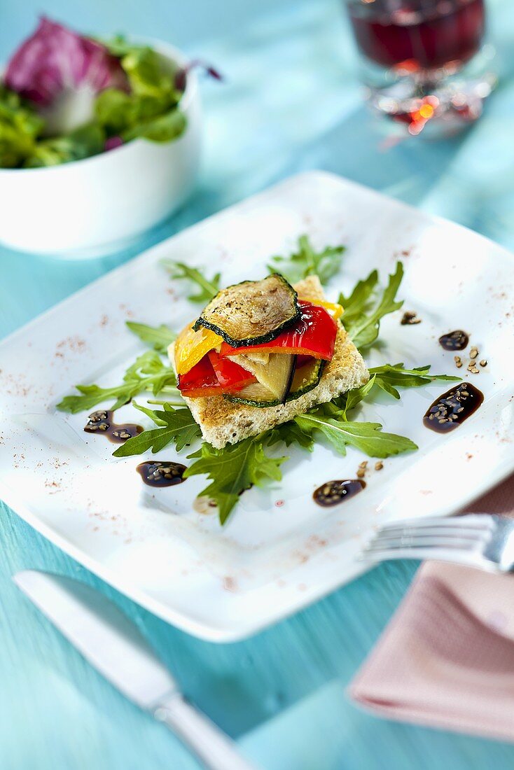 Toast with zucchini and pepper on rocket