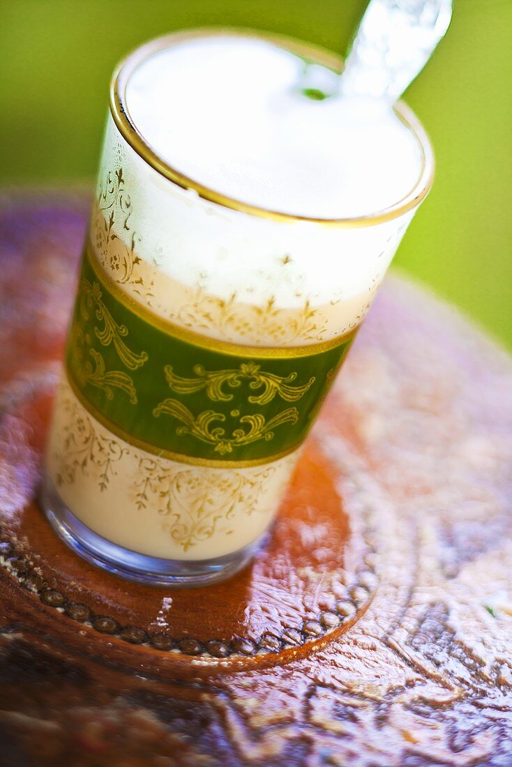 Chai Latte in a glass with an Asian design