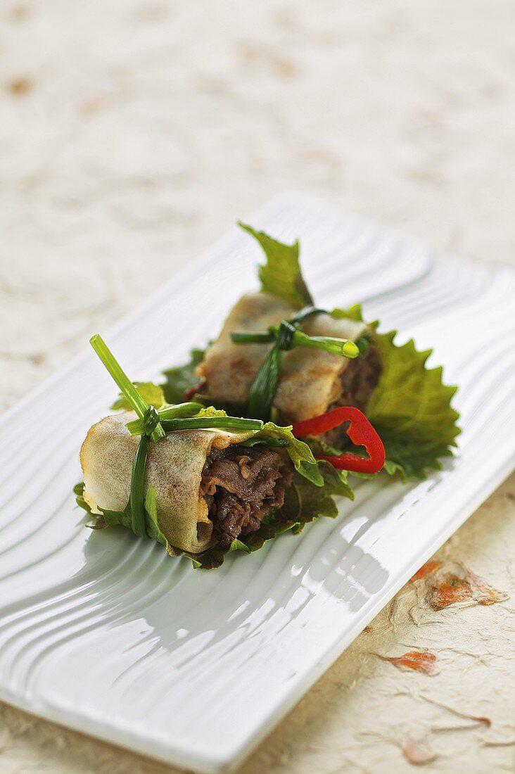 Marinated beef in a spring roll wrapper with Shiso leaves