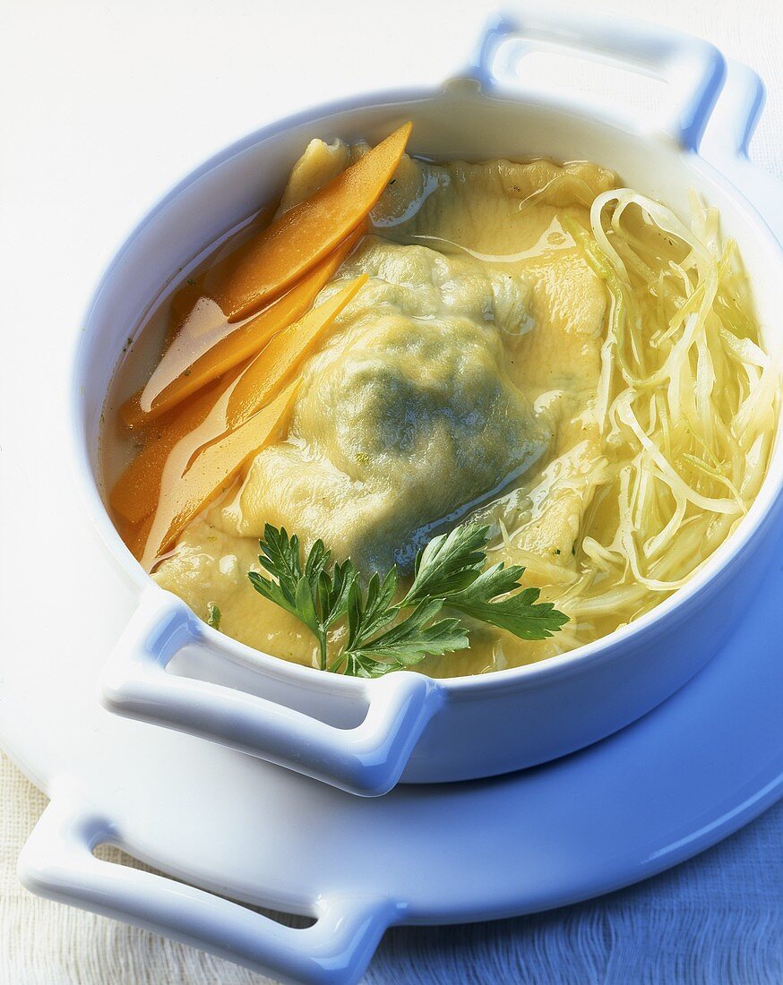 Broth with vegetables and turnovers filled with rabbit