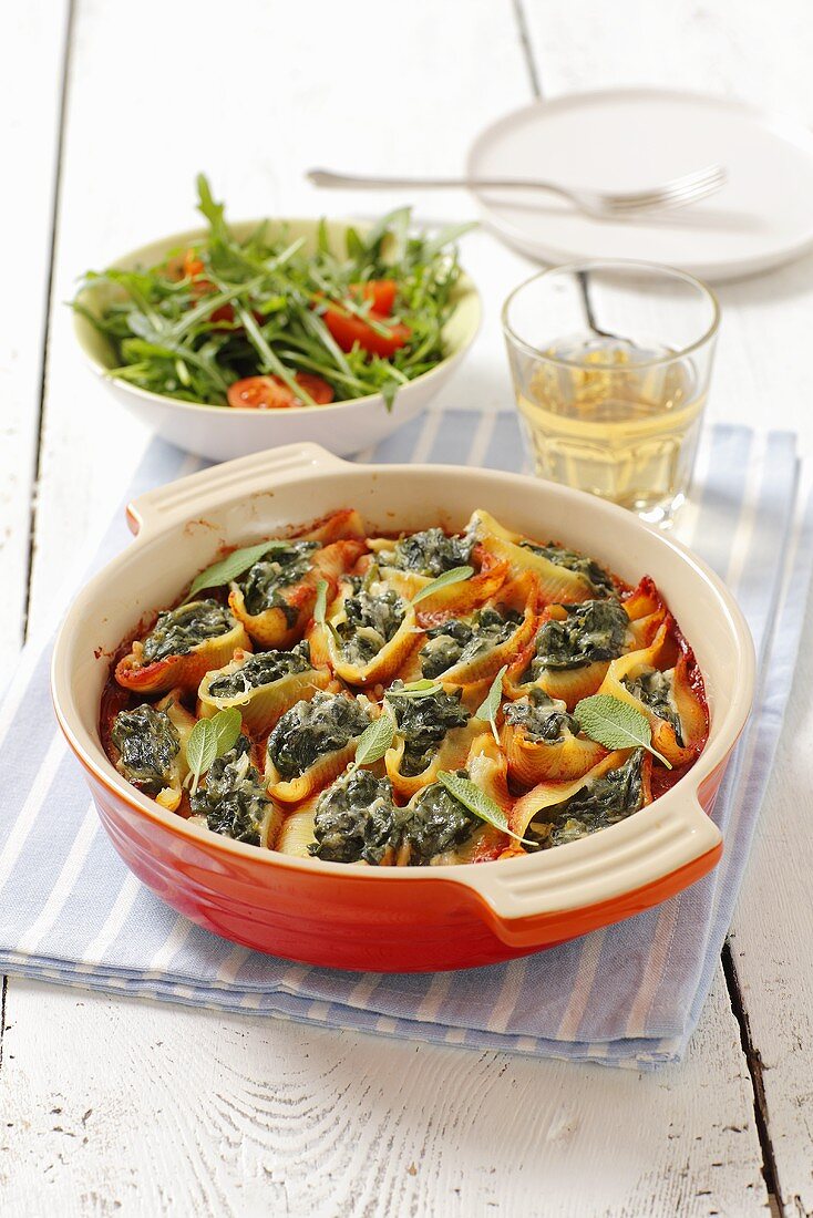 Conchiglie (pasta shells) with spinach filling and tomato sacue