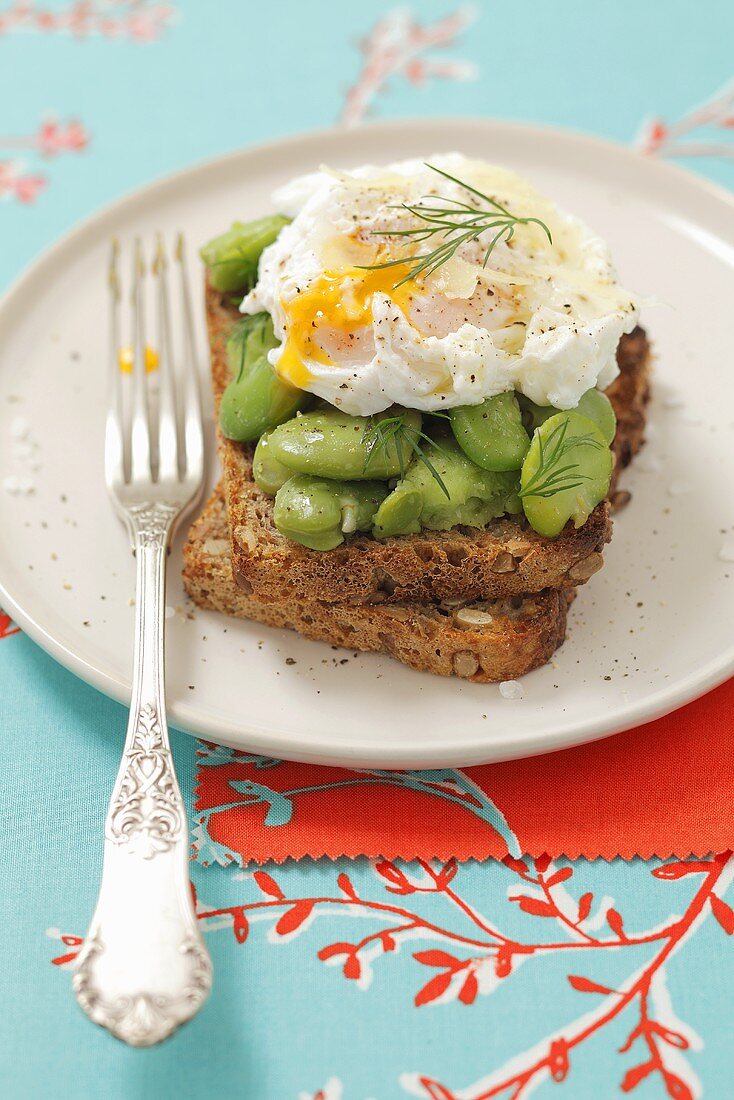 Whole wheat toast with lima beans and poached egg