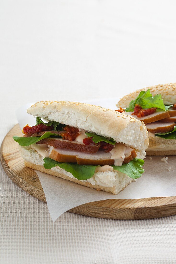 A chicken and harissa sauce sandwich on a baguette