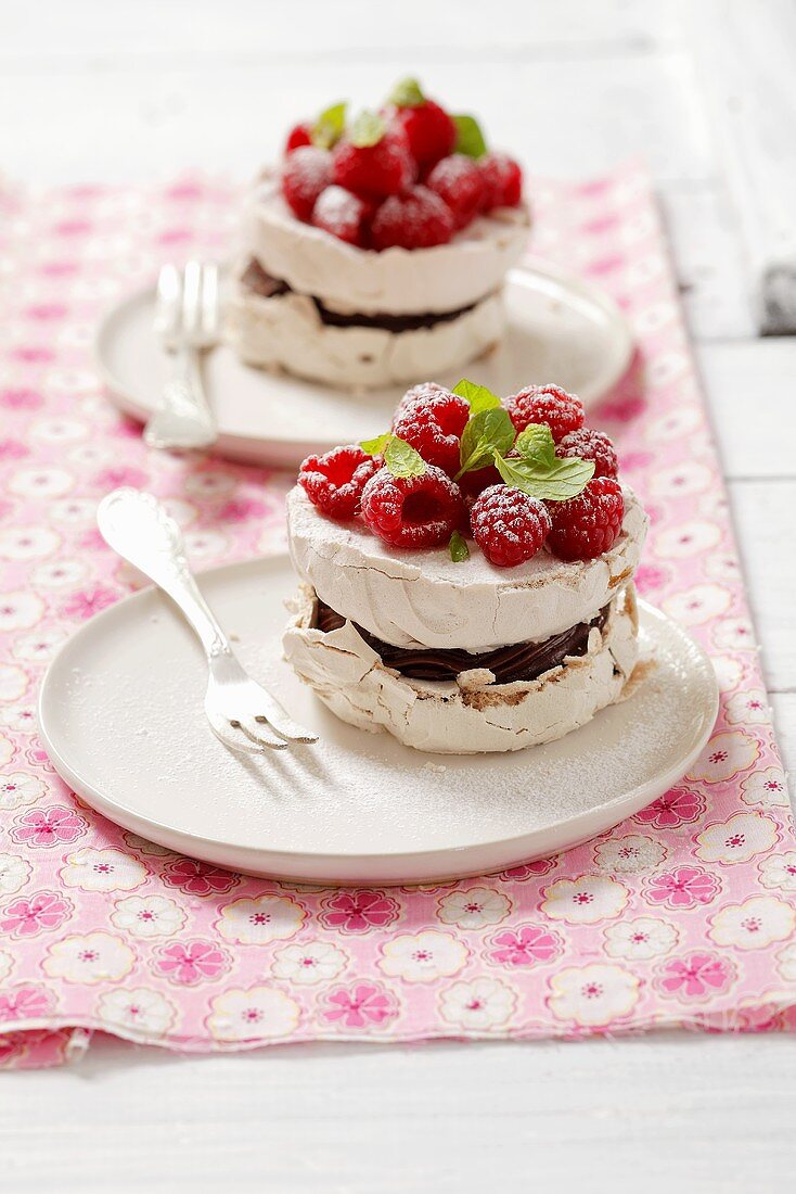 Meringues with chocolate cream and raspberries