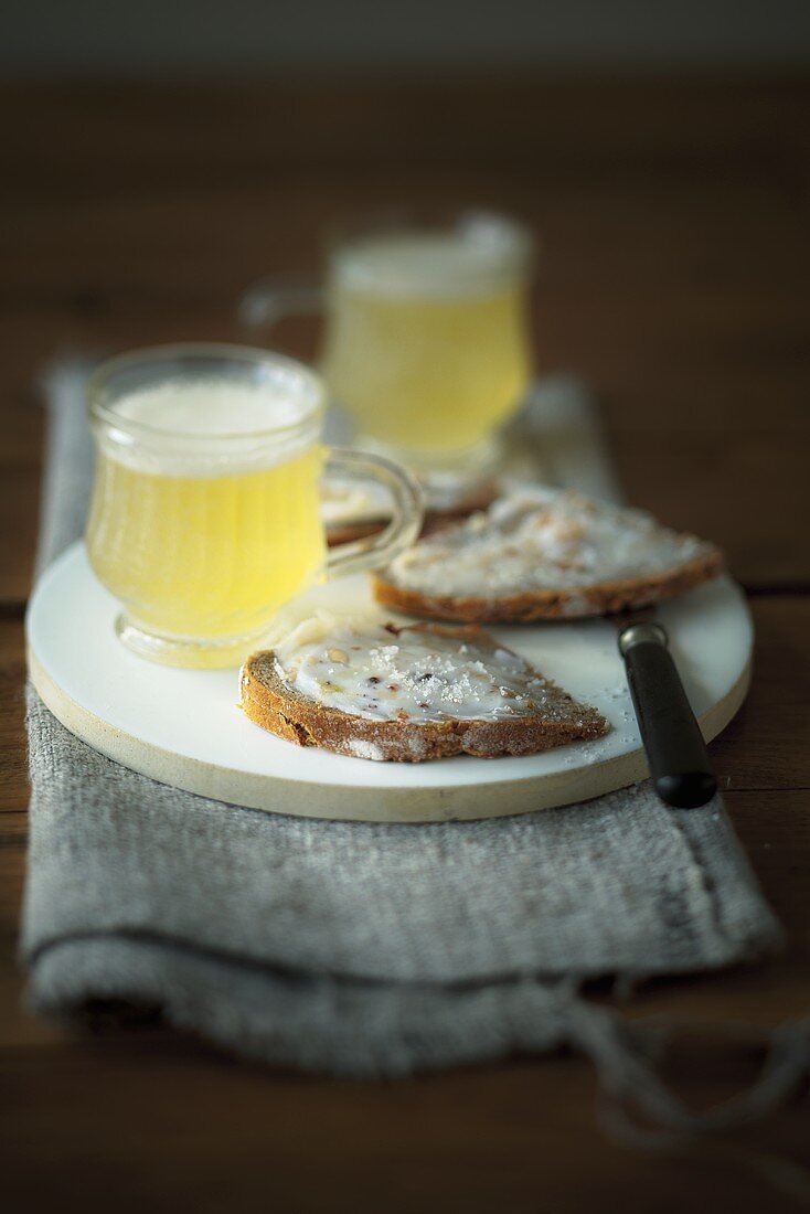 Bread spread with lard and crackling with shandy