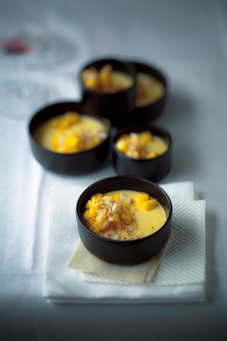 Saffron panna cotta with mango on a buffet table at a party