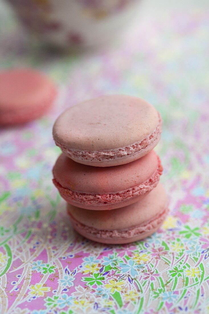 A stack of three rose and strawberry flavoured macaroons