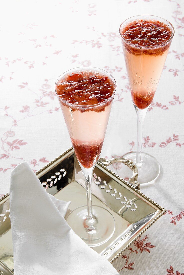 Two champagne cocktails with strawberry mousse