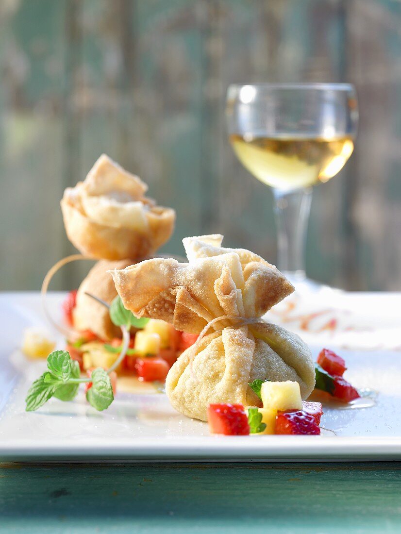 Baked cheese parcels with fruit salad