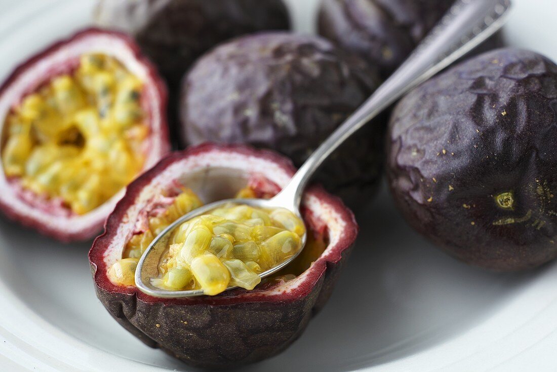 Passion fruit flesh being scooped out