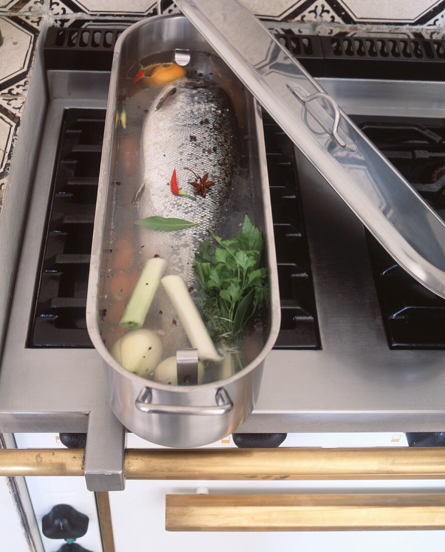 Salmon in a fish pot on a stove