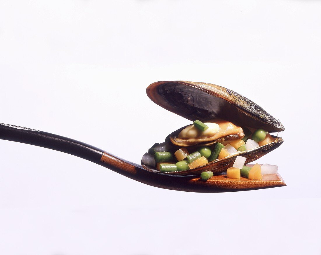 Mussels filed with vegetables on a spatula
