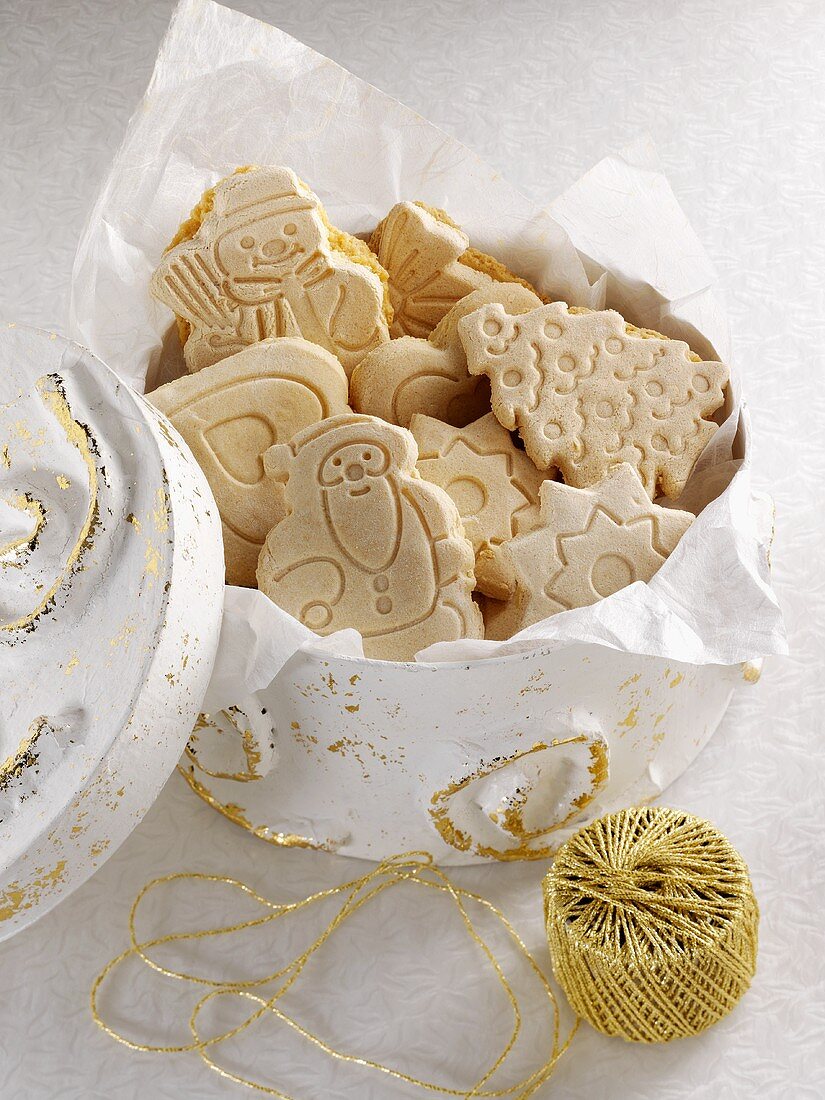 Springerle (embossed German Christmas biscuits) in a biscuit tin