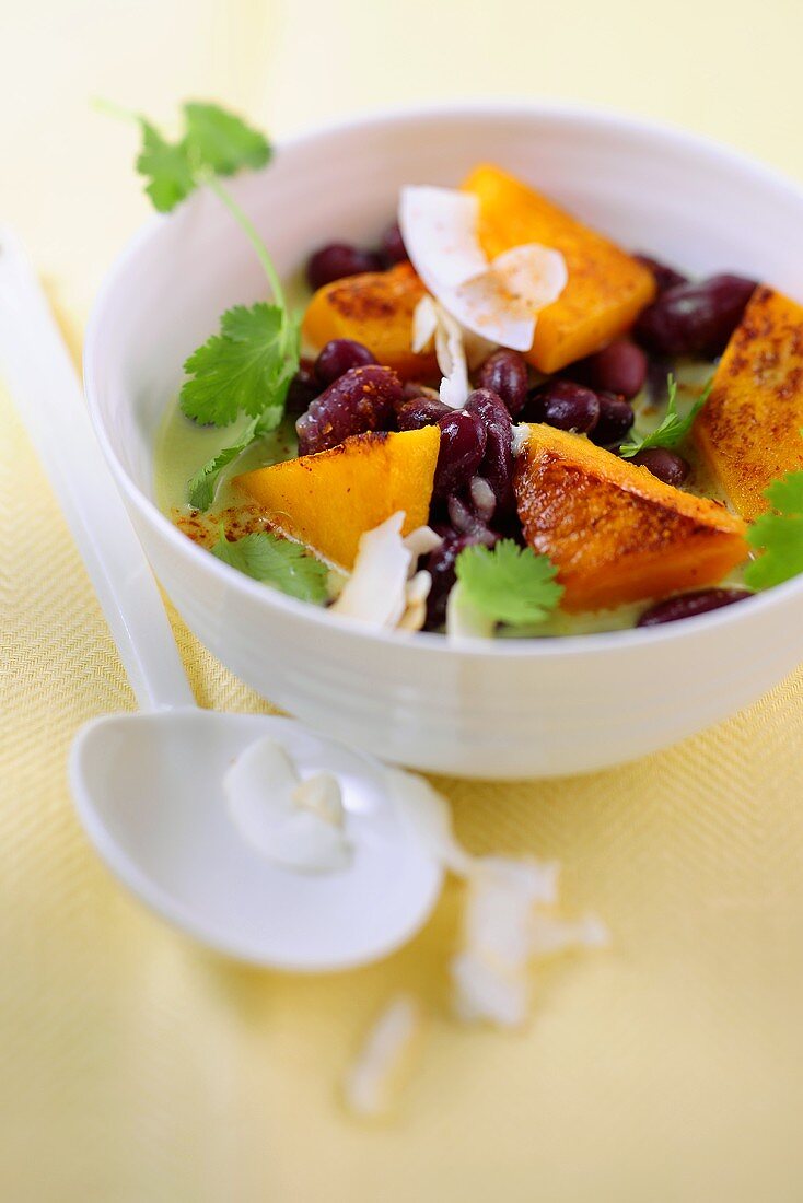 Pumpkin and bean curry with coconut chips