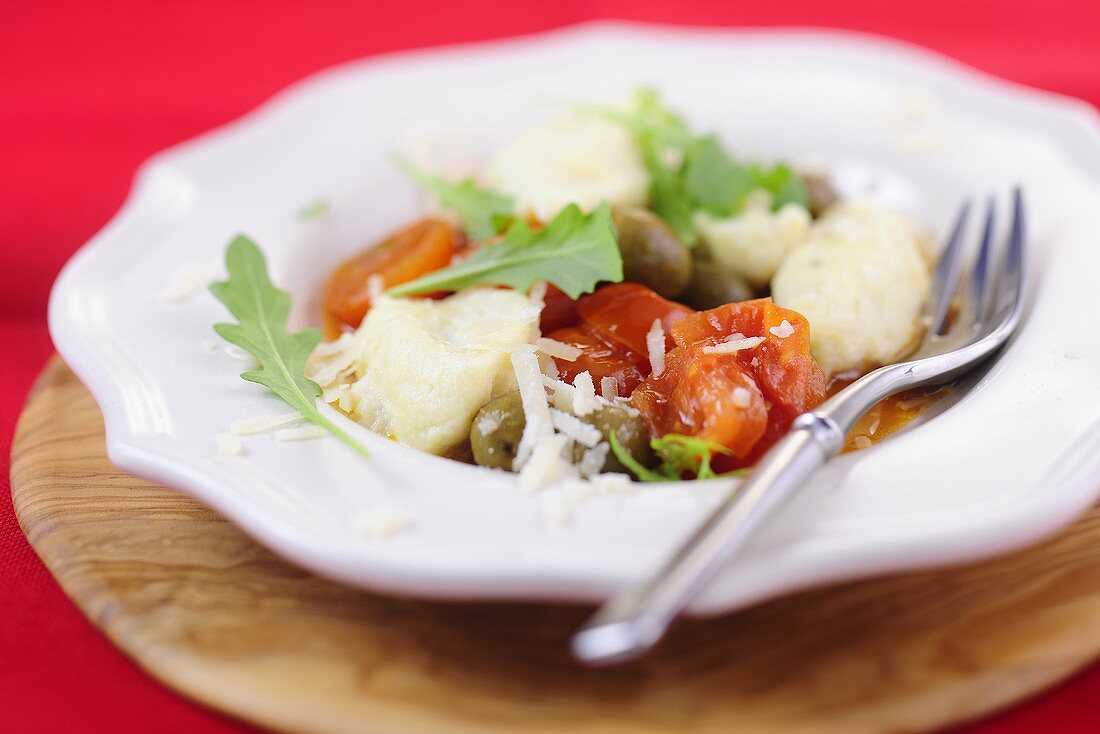 Ricotta gnocchi with a tomato and olive sauce