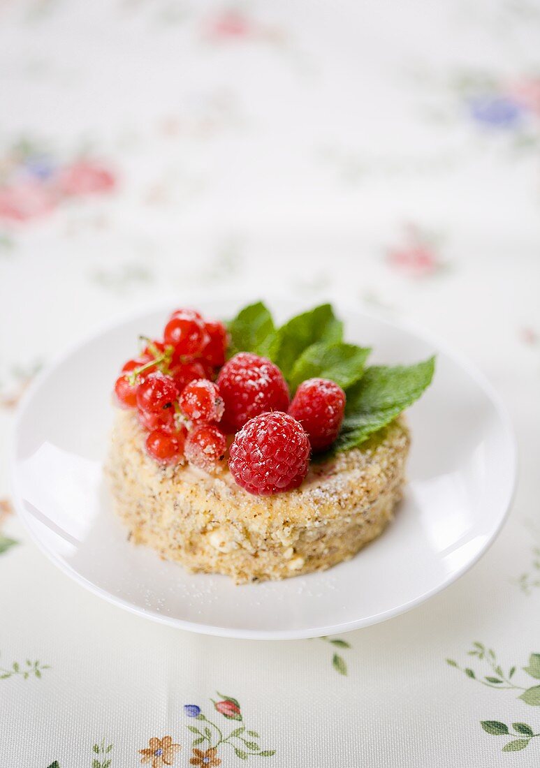 A sponge cake with raspberries and redcurrants