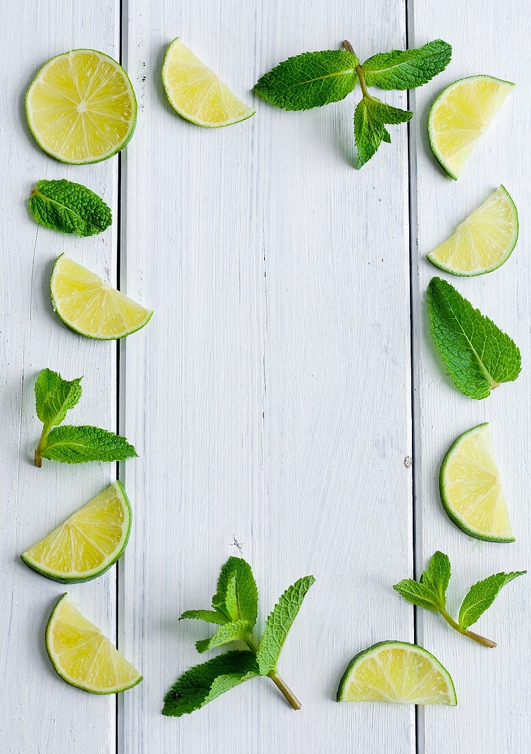 An arrangement of limes and mint leaves