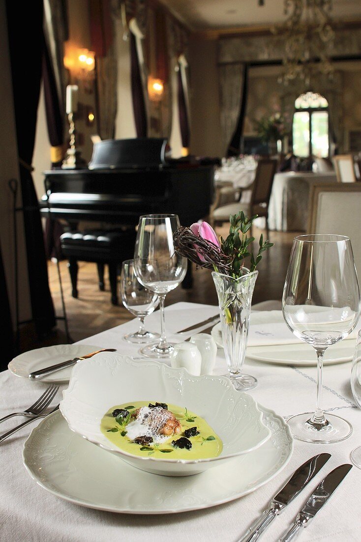Pea soup with snails in the hotel restaurant Chateau Mcely (Czech Republic)