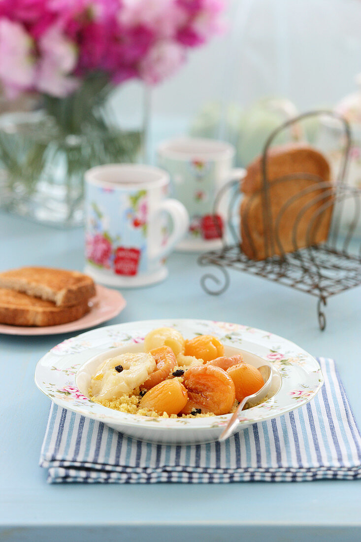 Sweet couscous with apricot compote for breakfast