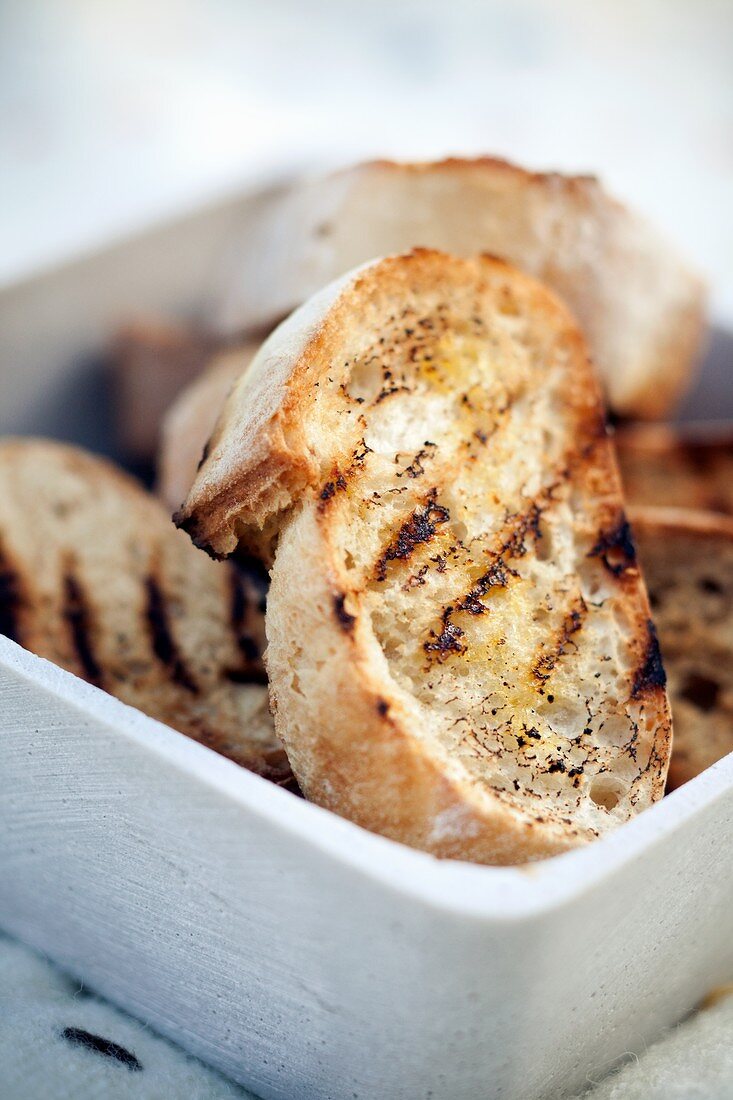 A bowl of toasted baguette slices