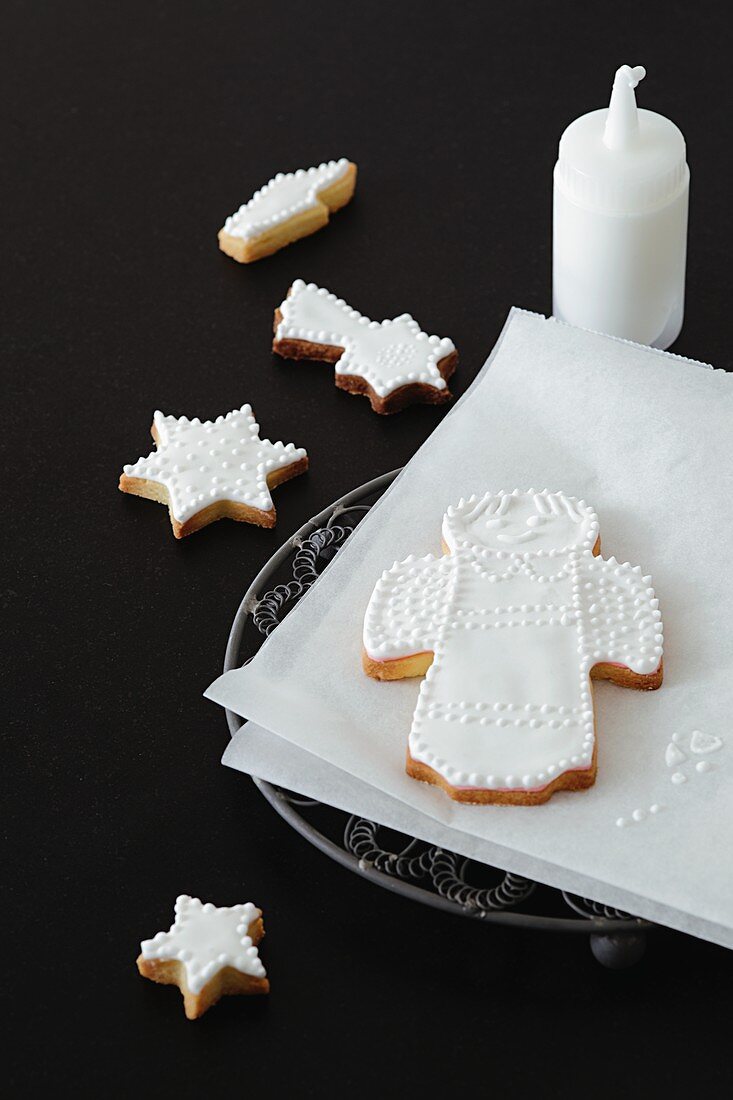 Shortbread biscuits with white icing (an angel and a star)