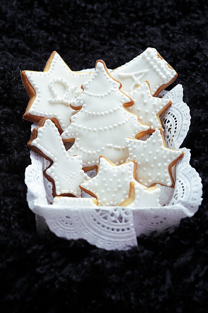 Shortbread biscuits with white icing on a doily