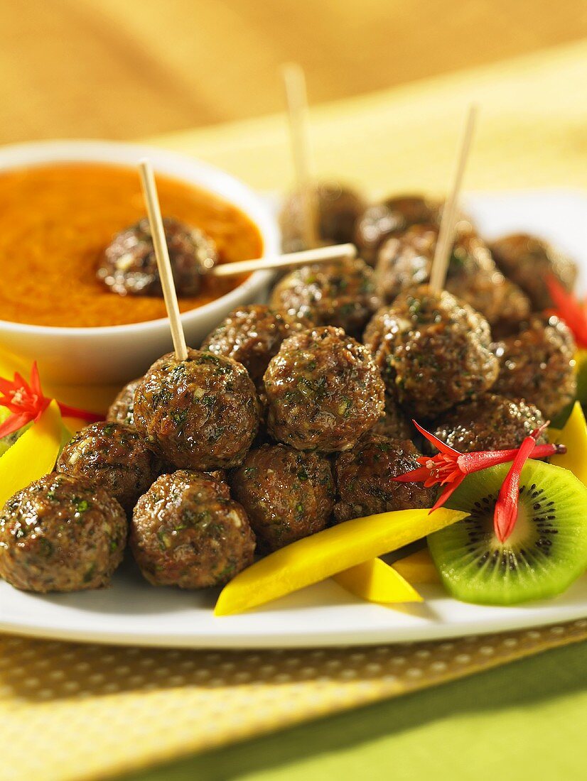 Mini meatballs on sticks with fruit and a dip (Thailand)