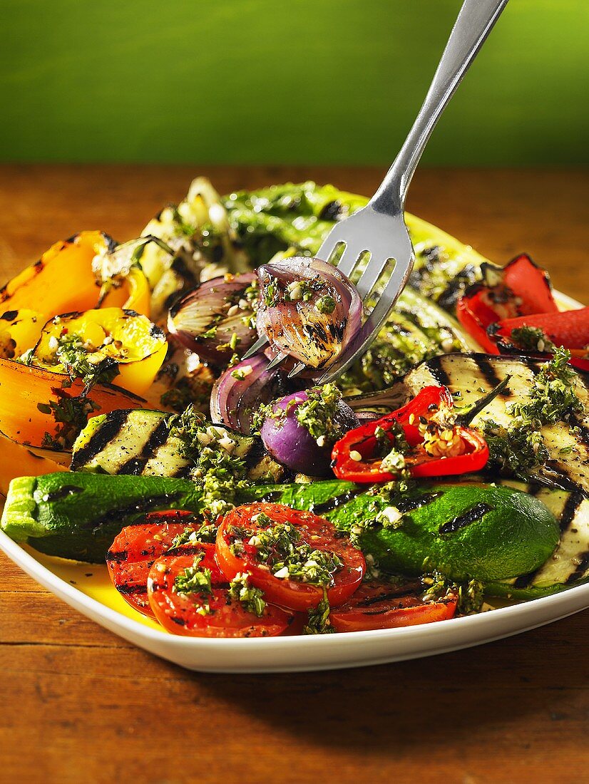 A grilled vegetable platter with herb sauce