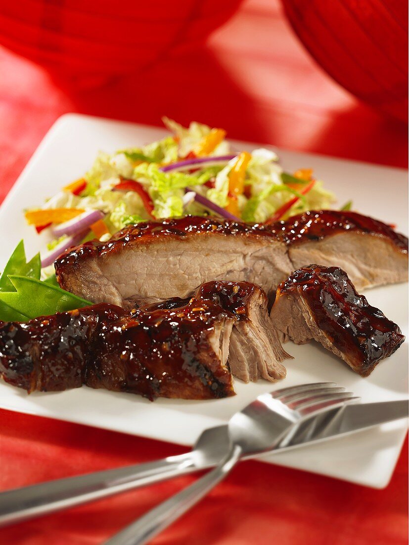 Pork ribs with a honey glaze and a side salad