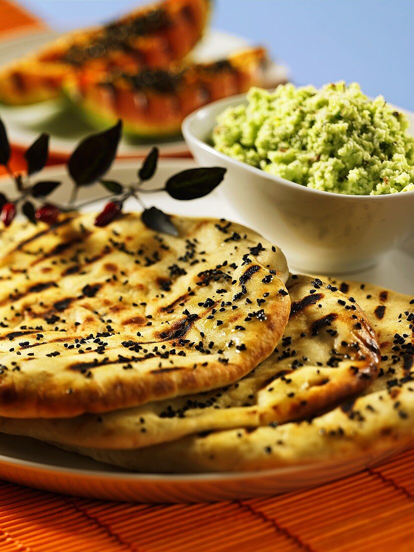 A stack of naan bread and a bowl of couscous (India)