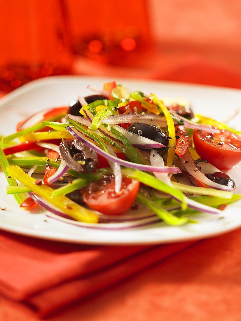 A colourful pepper salad with olives and tomatoes